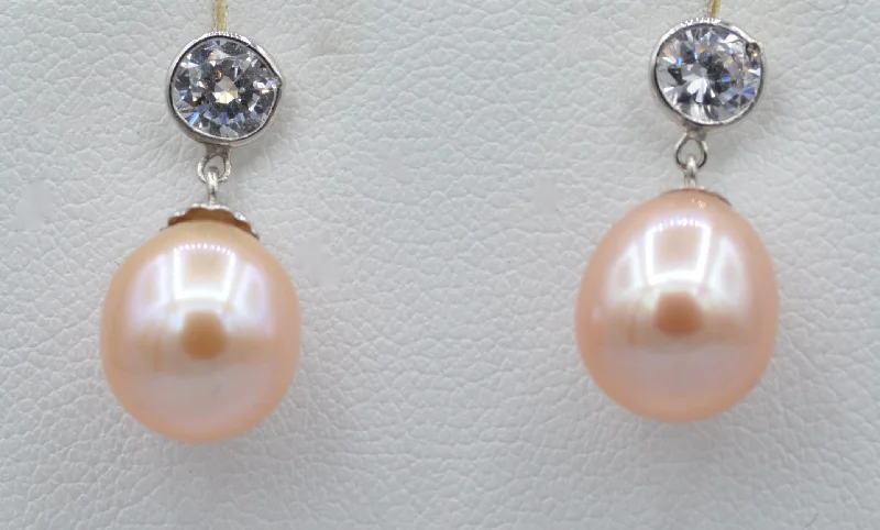 Ladies Earrings Wave Shine-14K white gold earrings with drop shaped pink fresh water pearls and 5mm Cubic Zirconia posts