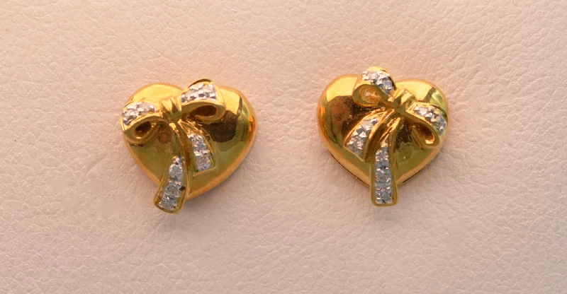 Ladies Earrings with Blue Sapphire-18k yellow gold, heart-shaped post  earrings with diamond bows.