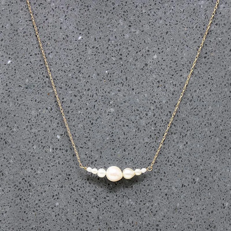 Ladies affordable chic necklaces -Glowing Pearl & Gold Arc Necklace by brunet